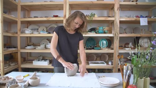 Woman Working with Clay in Pottery Studio