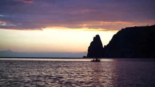Sea Landscape with Rocky Coastline on Sunset Time