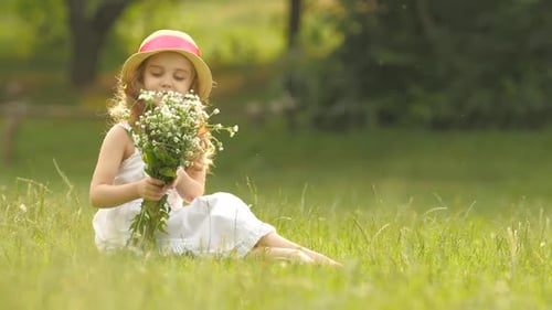 Girl Sits in Field with Wildflower Bouquet