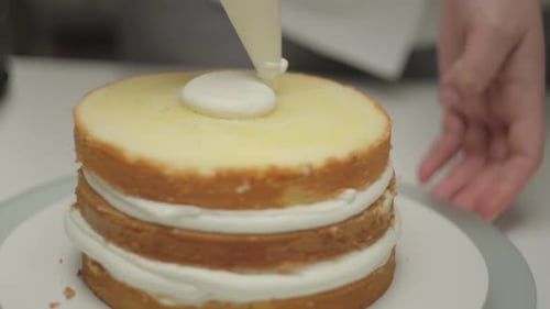 Icing a Delicious Layer Cake with White Frosting