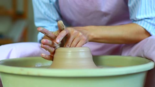 Potter Hands Sculpts a Vase From Clay on a Potter Close Up