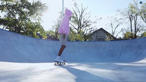 Young Adult Skateboarding in an Urban Skate Park