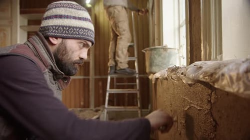 Construction Workers Applying Plaster to Interior Walls