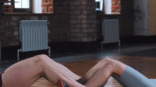 Attractive Adult Couple Training in the Gym Athletic Man and Tattooed Woman Pump Their Abs in Front
