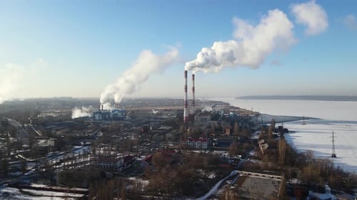 Aerial view of industrial zone with factory emissions of smoke from factory pipes in city