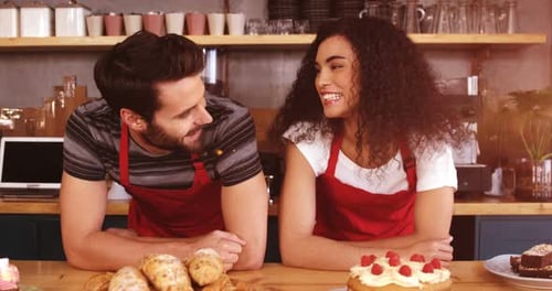 Smiling Cafe Workers Pose Behind the Counter