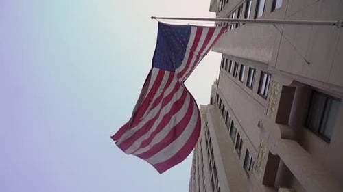 American Flag Waving on Building in City