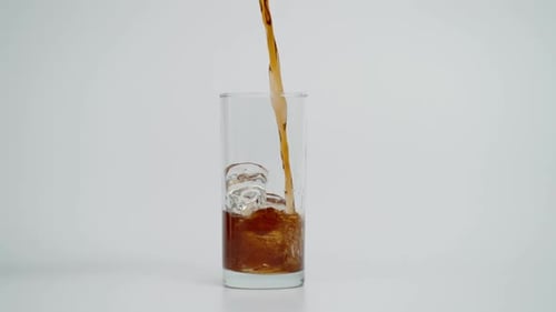 Brown Soda Refreshment Poured into Glass