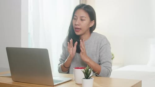 Woman Working on Laptop at Home