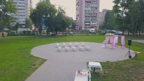 Wedding Venue with Pink Fabric and Flowers in Park Aerial