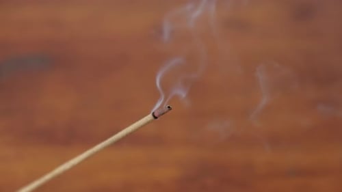 Incense Stick Burning Slowly, Releasing Smoke