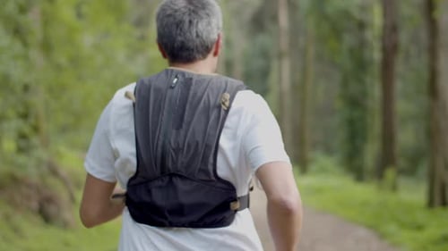 Man Running on Trail in Forest