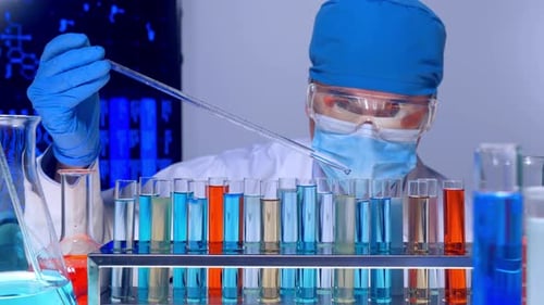 Scientist Testing Chemicals in Laboratory with Pipette