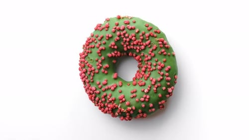 Closeup Sweet Delicious Donut with Green Glaze and Pink Pastry Topping