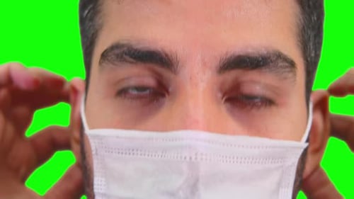 Young Adult Putting on Protective Mask, Chroma Key