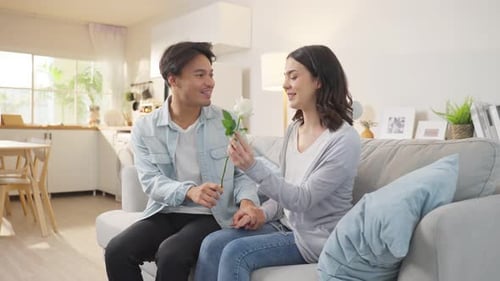 Loving Couple Embrace with Rose in Sunny Home
