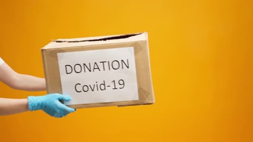 Hands Holding Donation Box for Covid-19