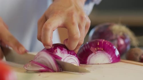 Close up shot of man cutting an onion