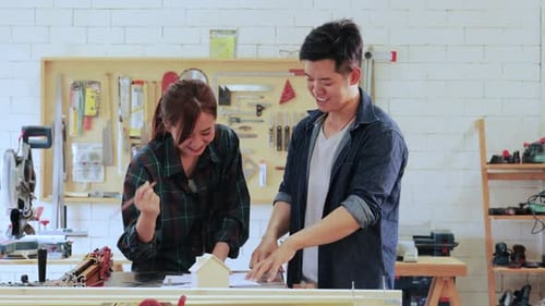 Teamwork in Workshop With Model House