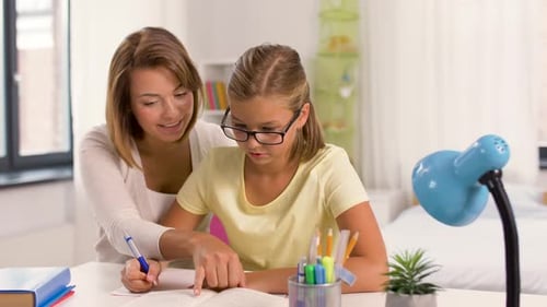 Woman Helping Child Study at Home