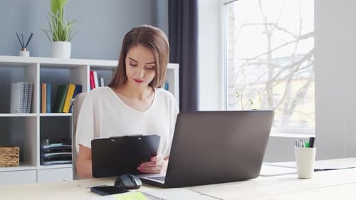 Young Woman Works at Home Office Using Computer.