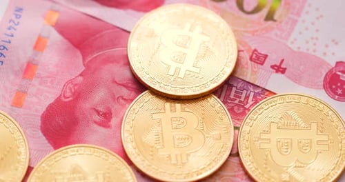 Gold Bitcoins on Chinese Yuan Banknotes