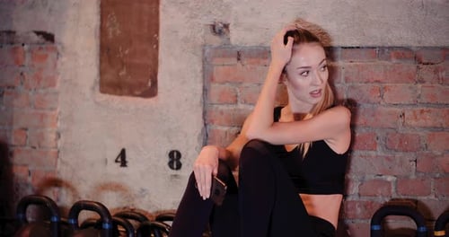 Fit Young Woman Using Smartphone In Gym