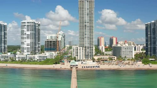 Aerial Miami Beach Front Buildings with White Clouds in Blue Sky on Background