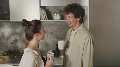 Couple Talking in Kitchen over Coffee