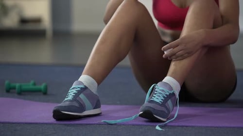 Adult Tying Shoe Laces After Workout