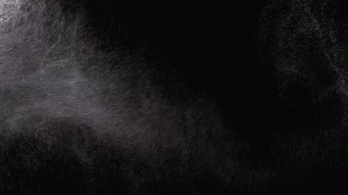 Abstract Water Droplets Falling Against Black Backdrop