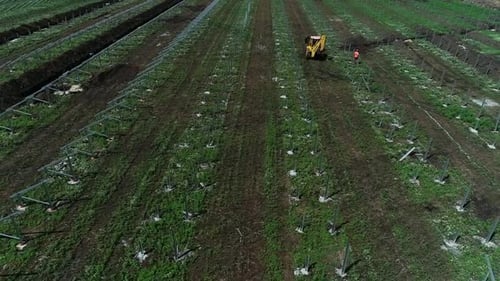 Drone View of the Rows of Racks to Hold Solar Panels Excavator and Worker