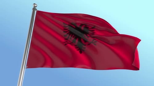 Albanian Flag Waving on Flagpole with Clear Blue Sky Background