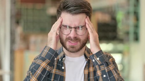 Portrait of Tired Young Man Having Headache