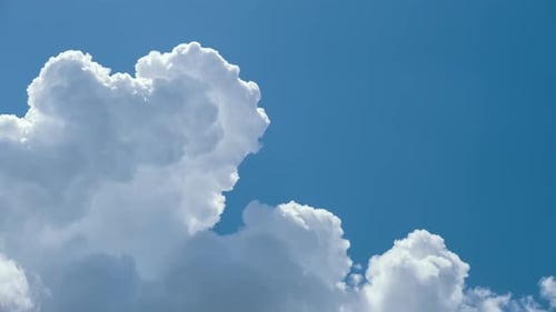 Fluffy White Clouds Floating in a Blue Sky