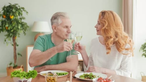 Happy Couple Toasts with Wine at Home