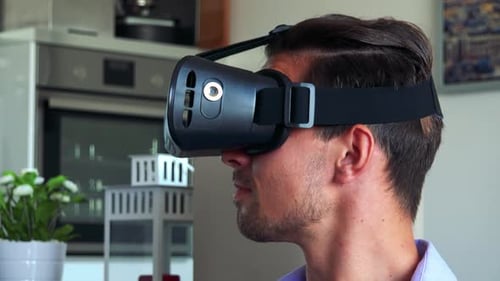 Man Experiencing Virtual Reality with Headset at Home