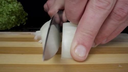 Close Up Of Onion Being Diced For Cooking
