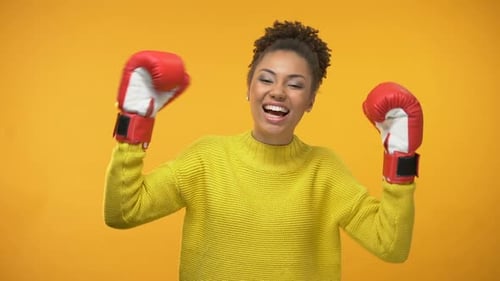 Excited Woman with Boxing Gloves Celebrates Victory
