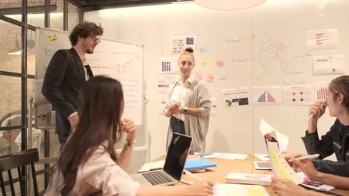 Business Team Meeting Discussing Data and Charts