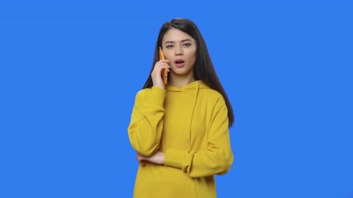 Young Woman Answering Phone On Chroma Key Background