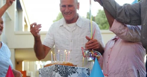 Seniors Celebrating Birthday with Cake and Sparklers