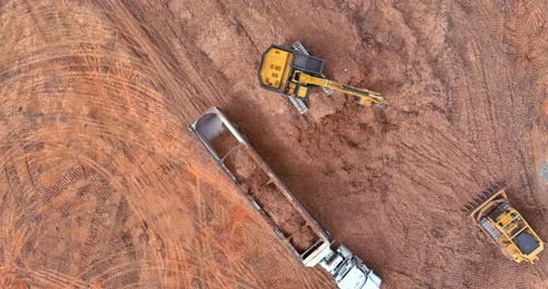 Birds Eye View of Excavator Loading Truck at Site