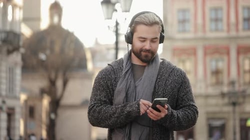 Man Listening Music on Phone in City Street