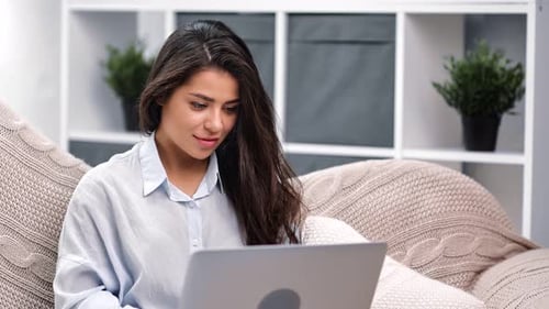 Young Woman Working on Laptop at Home