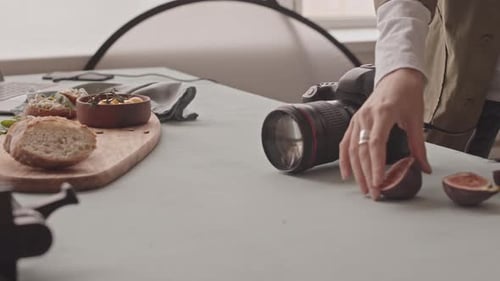 Food Photographer Arranging Appetizing Charcuterie Board Display