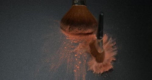 Make-up Brush spreading blush powder on black background, Slow motion 4K