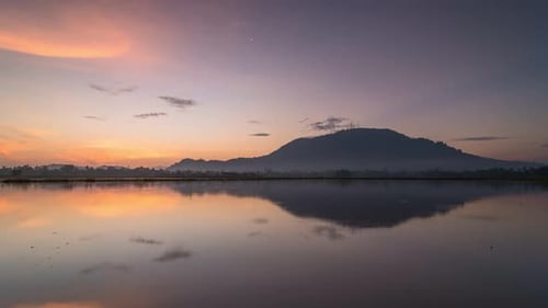 Timelapse reflection sunrise with golden cloud formation