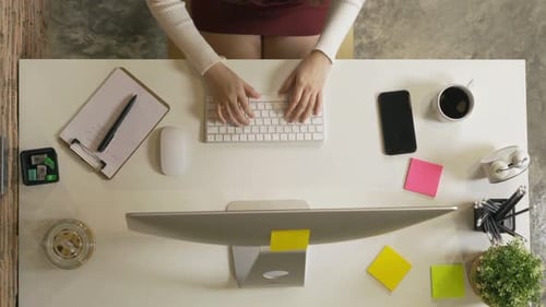Top view of smiling Asian business woman, person working from home, typing on a keyboard