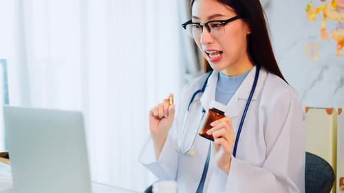 Woman Doctor Video Conferencing with Patient